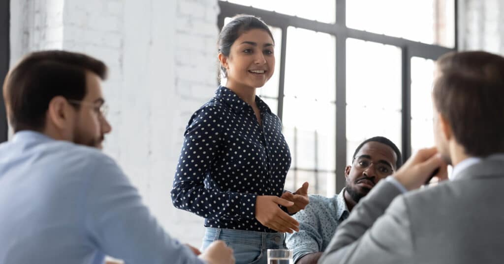 Indian businesswoman speaking up in all male meeting