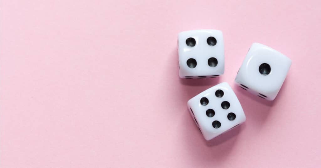 white dice on pink background