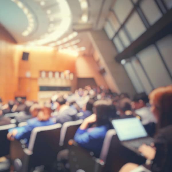 Blur of auditorium room use for present meeting background.