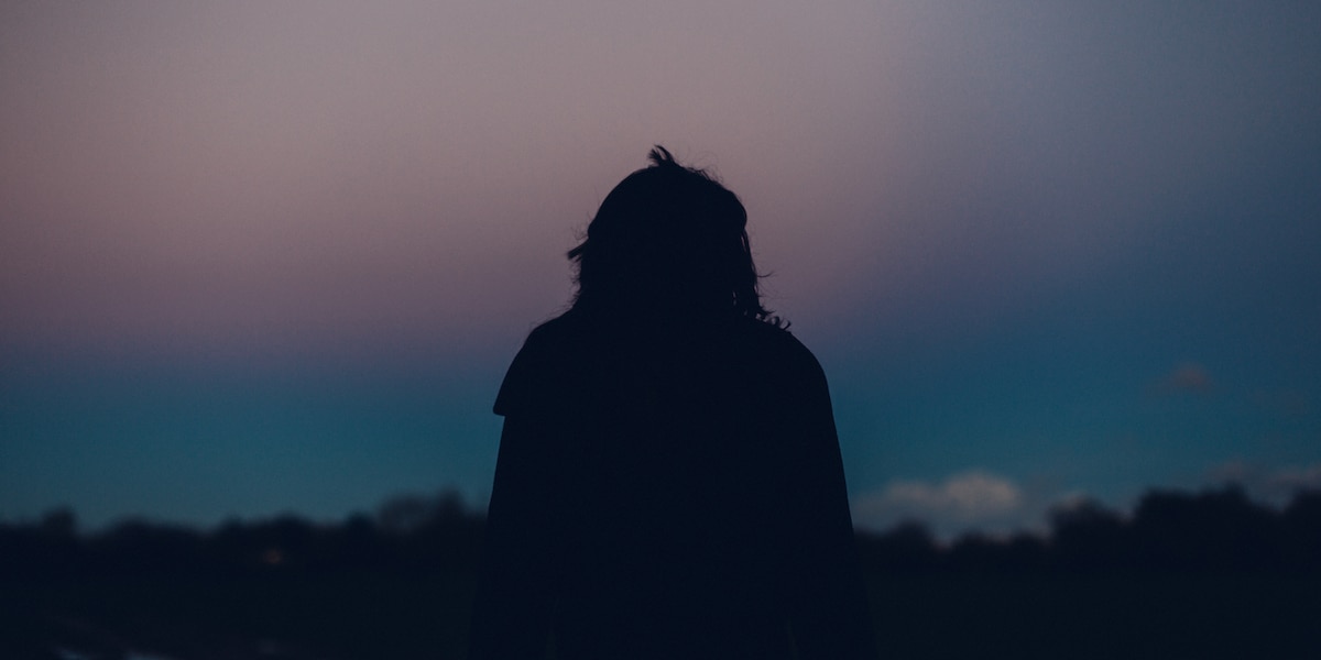 Woman watching sunset alone