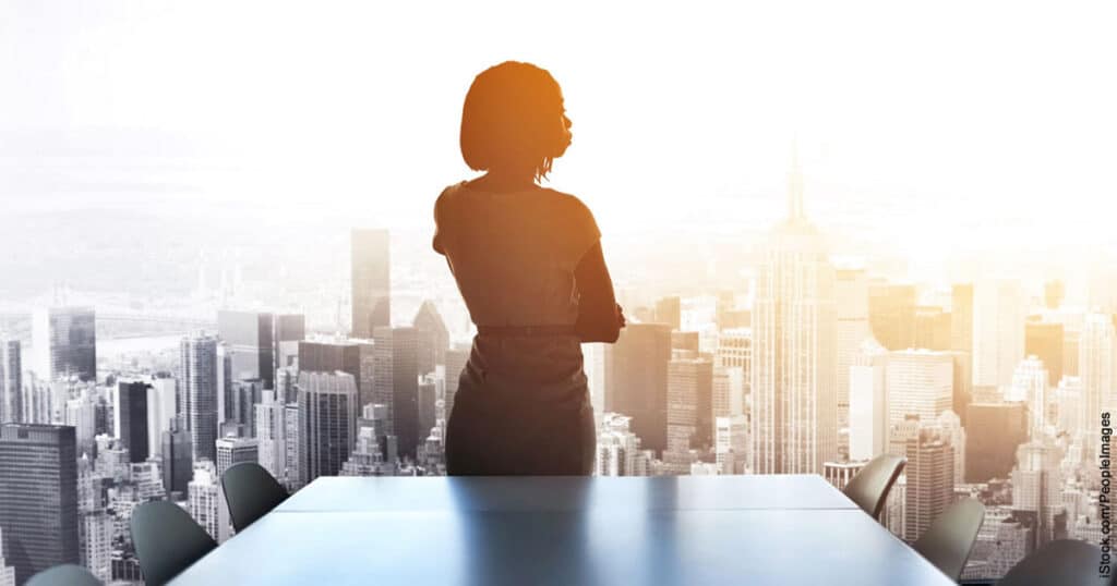 rearview shot of a woman executive staring out of a boardroom highrise window