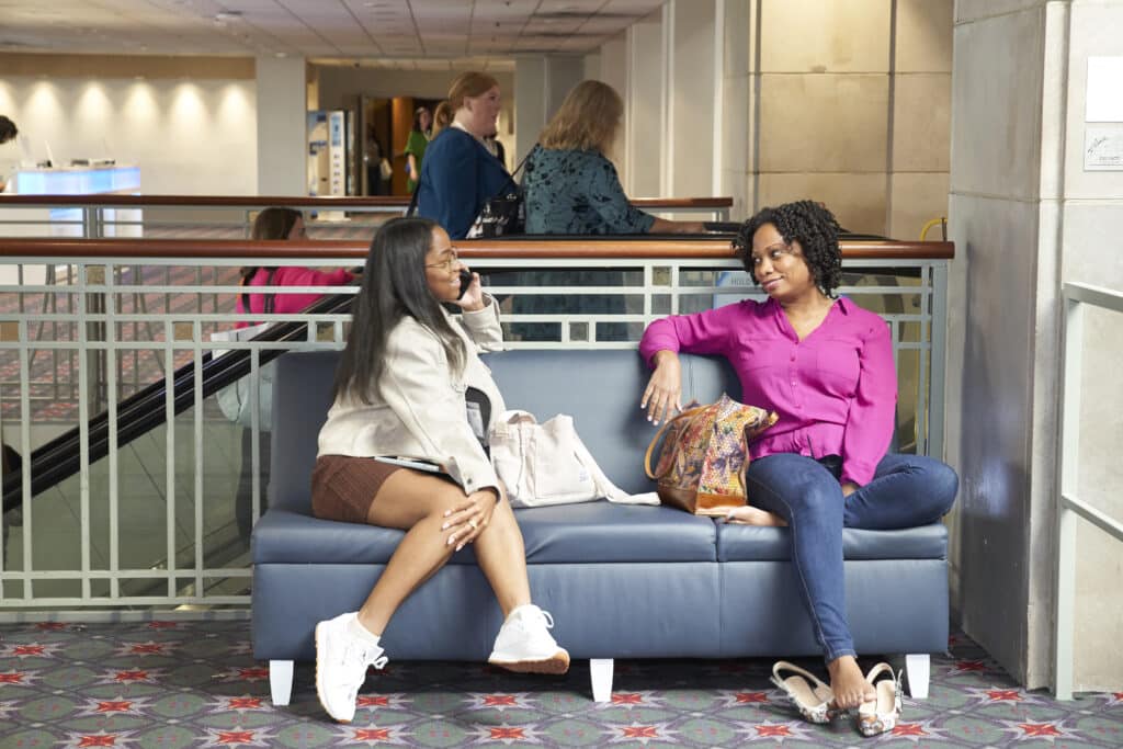 Attendees chatting in the Conference lounge