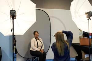 attendee having her photo taken by a professional photographer at the Conference