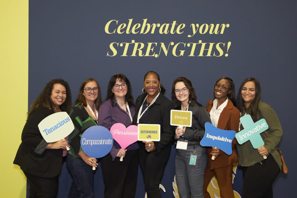 Attendees celebrating their strengths in the Conference photo booth